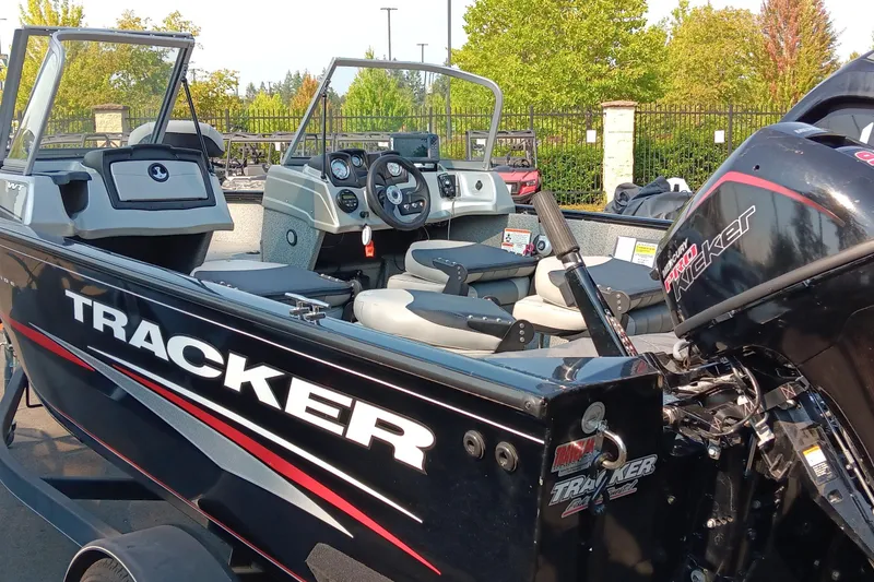Slide: The Image of 2017 Tracker Pro Guide V-175 WT boat with Mercury outboard motor, parked outdoors. - 3