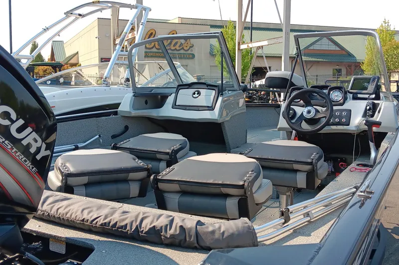 Slide: The Image of 2017 Tracker Pro Guide V-175 WT boat interior with Mercury engine, featuring seating and control panel. - 4