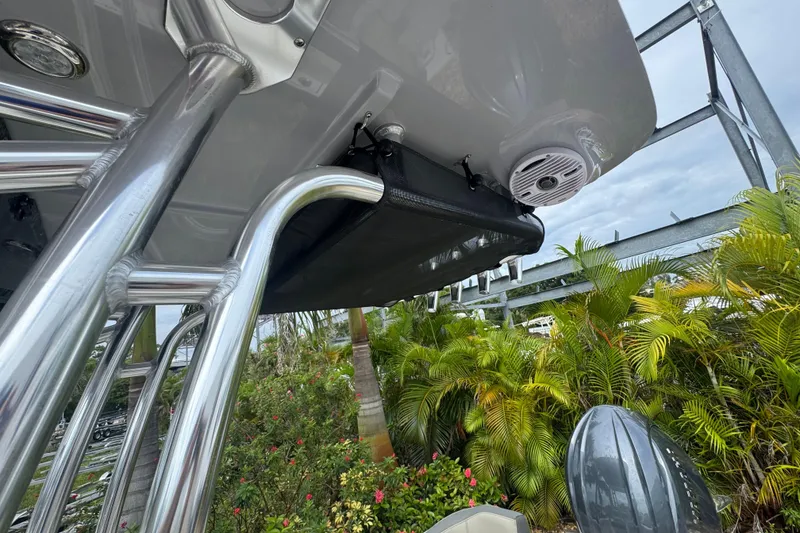 Slide: The Image of 2026 Key West 203 FS boat with stainless steel frame and speaker, surrounded by lush greenery. - 10
