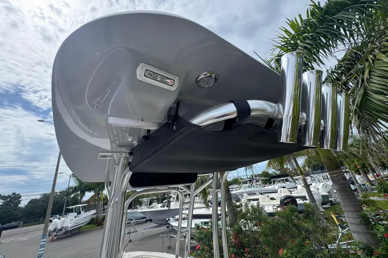 Slide: The Image of 2026 Key West 203 FS boat with T-top and rod holders, surrounded by palm trees. - 14