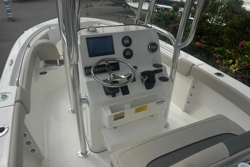 Slide: The Image of 2026 Key West 203 FS boat interior with steering console and seating. - 16
