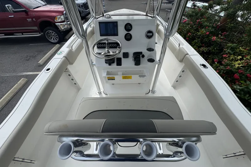 Slide: The Image of 2026 Key West 203 FS boat console with steering wheel and controls, parked outdoors. - 19