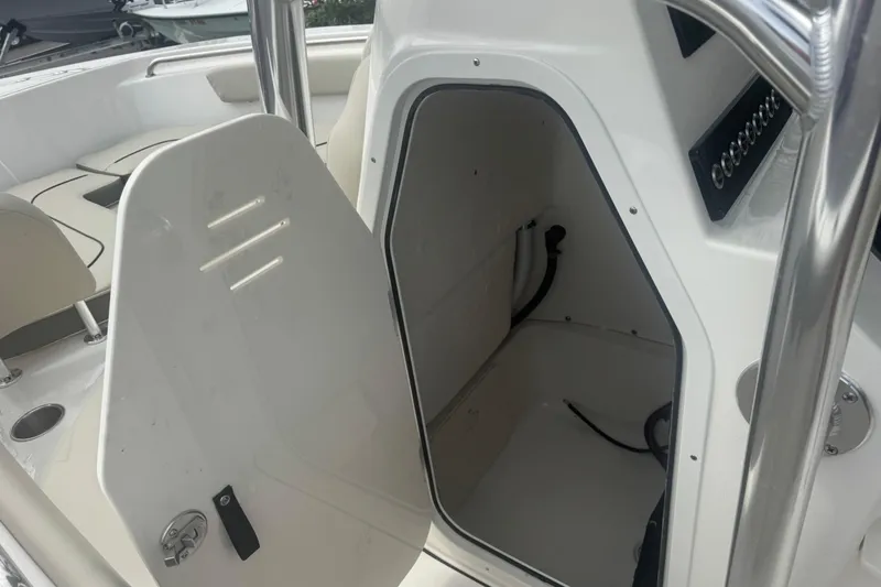 Slide: The Image of 2026 Key West 203 FS boat interior storage compartment with open door. - 25