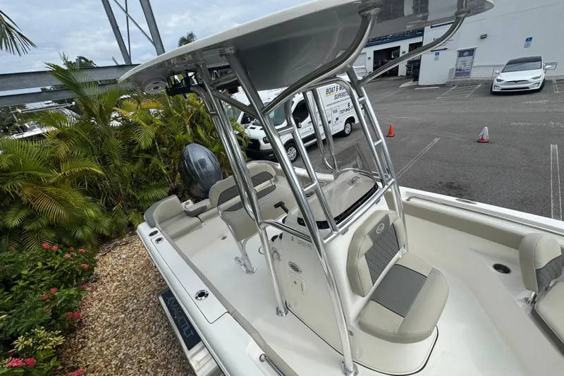 Slide: The Image of 2026 Key West 203 FS boat with T-top, parked near tropical plants. - 31