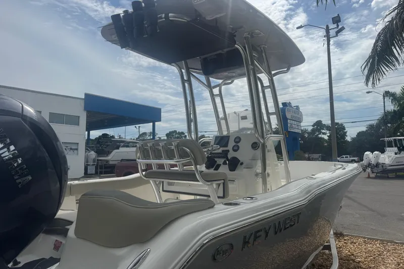 Slide: The Image of 2026 Key West 203 FS boat with Yamaha engine, parked outdoors under cloudy sky. - 5