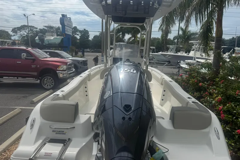Slide: The Image of 2026 Key West 203 FS boat with powerful outboard motor in a sunny marina setting. - 7