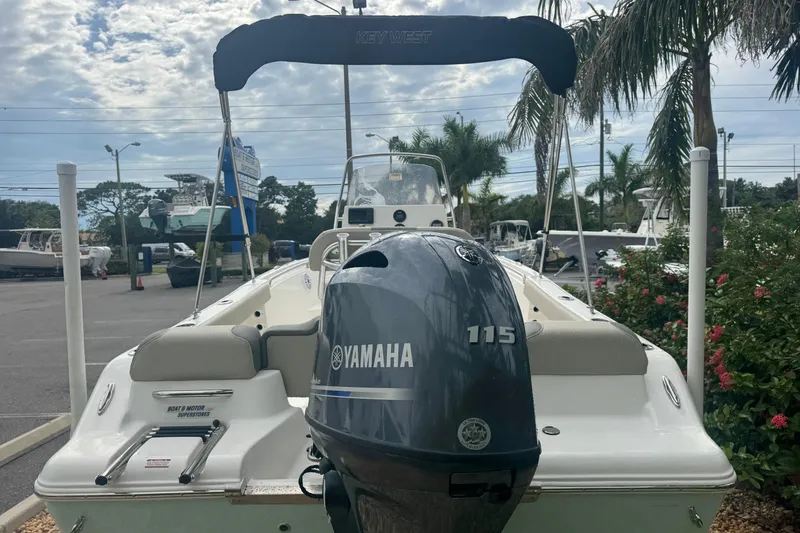 Slide: The Image of 2026 Key West 189 FS boat with Yamaha 115 engine, parked outdoors. - 11