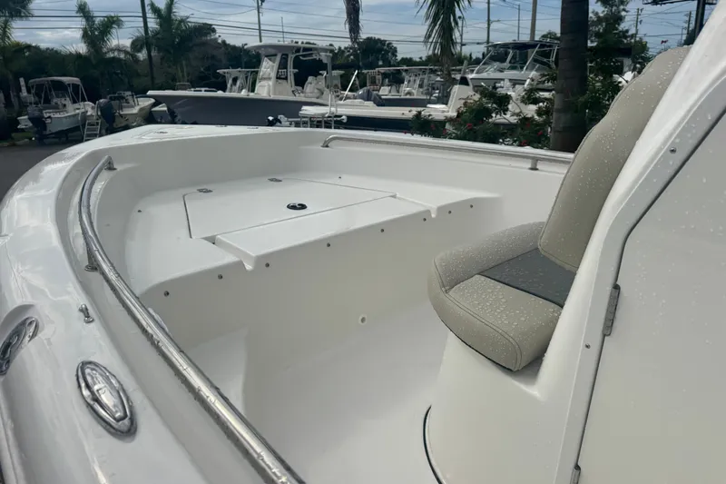 Slide: The Image of 2026 Key West 189 FS boat interior with seating and storage, parked among other boats. - 17