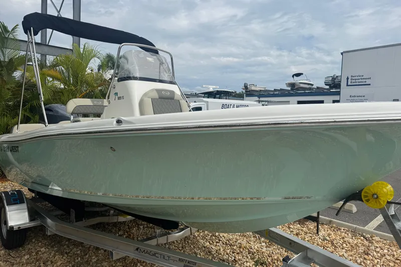 Slide: The Image of 2026 Key West 189 FS boat on trailer, displayed outdoors with palm trees. - 5