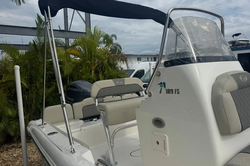 Slide: The Image of 2026 Key West 189 FS boat with seating and canopy, parked outdoors. - 6