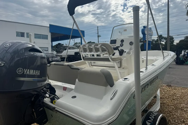 Slide: The Image of 2026 Key West 189 FS boat with Yamaha engine, parked outdoors under cloudy sky. - 9