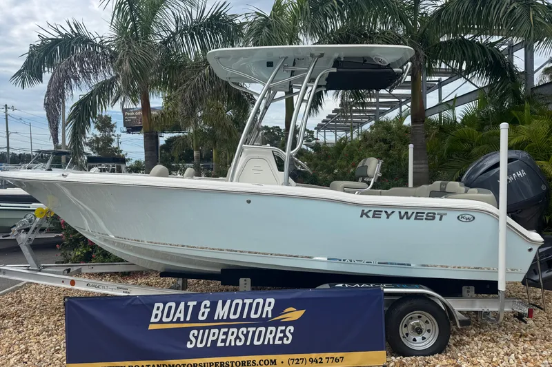 The Image of 2026 Key West 203 FS boat displayed at Boat & Motor Superstores, surrounded by palm trees. - 1