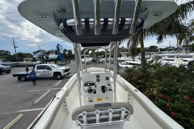 Slide: The Image of 2026 Key West 203 FS boat in marina, surrounded by palm trees and parked vehicles. - 11