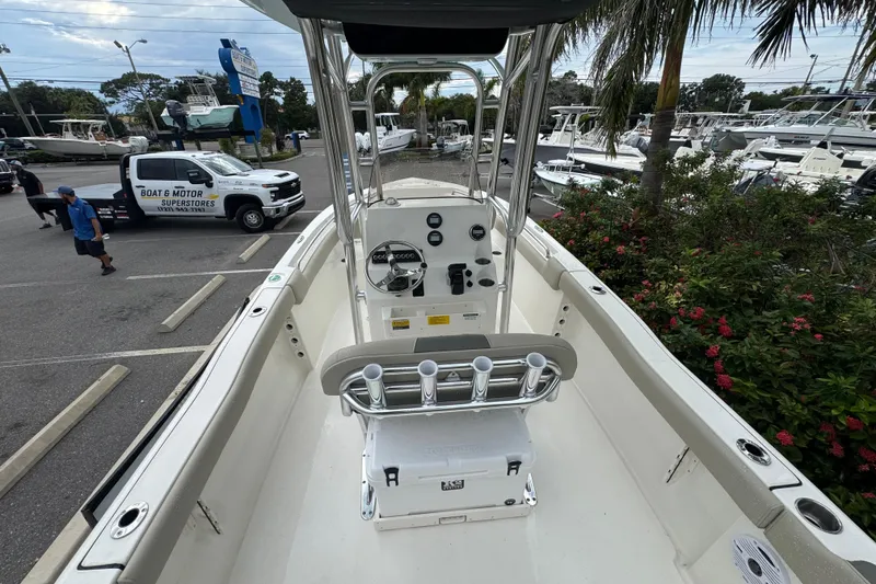 Slide: The Image of 2026 Key West 203 FS boat interior with console, parked at dealership. - 12