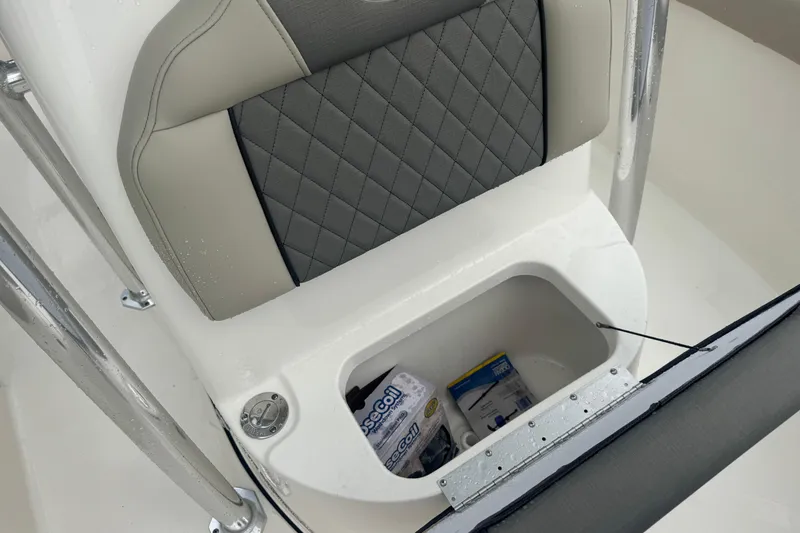 Slide: The Image of 2026 Key West 203 FS boat seat with storage compartment, featuring gray and beige upholstery. - 23