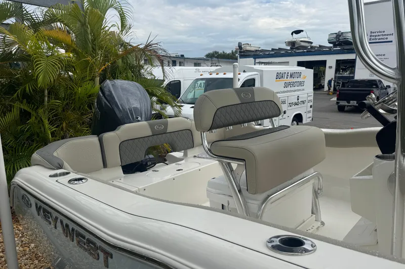 Slide: The Image of 2026 Key West 203 FS boat with seating, parked near service center. - 6