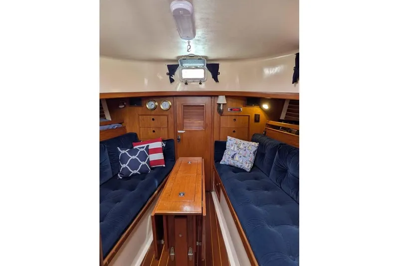 Slide: The Image of Interior of 1983 Nonsuch 30 Classic sailboat with cozy seating and nautical decor. - 11