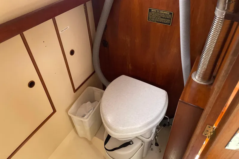 Slide: The Image of 1983 Nonsuch 30 Classic boat bathroom with toilet and storage compartments. - 14