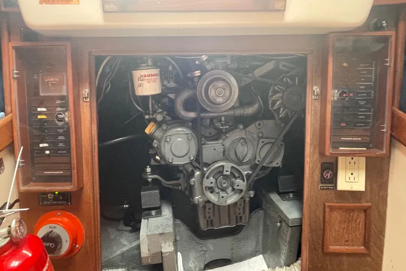 Slide: The Image of Engine compartment of a 1983 Nonsuch 30 Classic sailboat, featuring a Yanmar engine. - 18