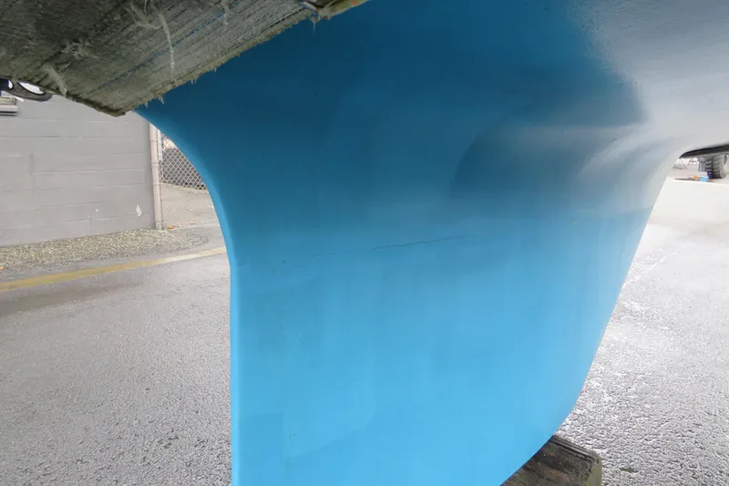 Slide: The Image of Blue hull of 1983 Nonsuch 30 Classic sailboat on dry dock. - 25