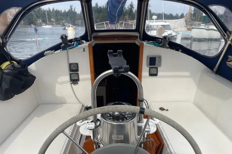 Slide: The Image of Cockpit of 1983 Nonsuch 30 Classic sailboat with steering wheel and navigation instruments. - 7