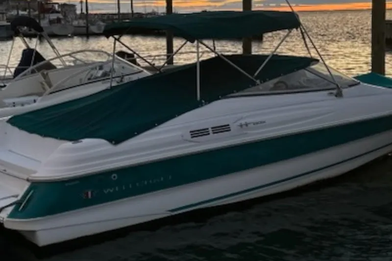 Slide: The Image of 1996 Wellcraft 2600s Eclipse Bowrider boat docked at sunset. - 1