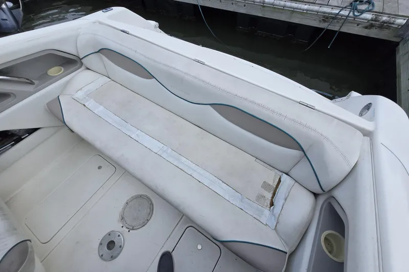 Slide: The Image of 1996 Wellcraft 2600s Eclipse Bowrider interior seating with white upholstery and storage compartments. - 11