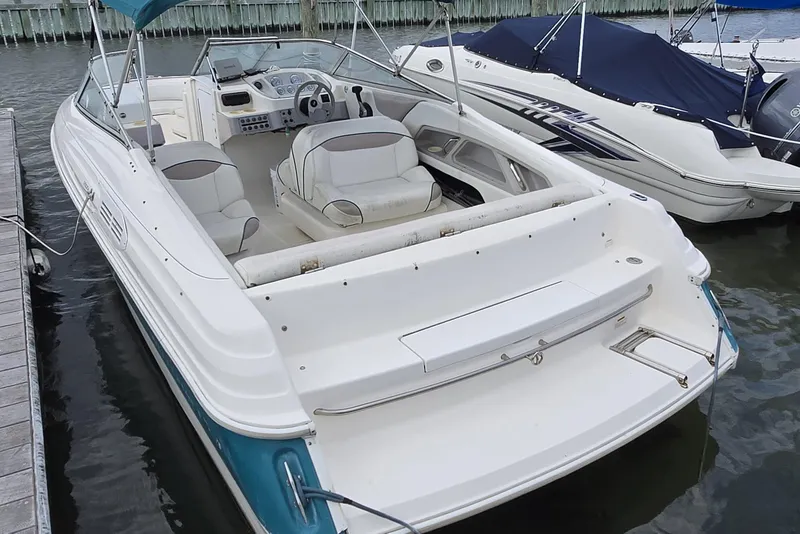 Slide: The Image of 1996 Wellcraft 2600s Eclipse Bowrider docked, featuring spacious seating and sleek design. - 12