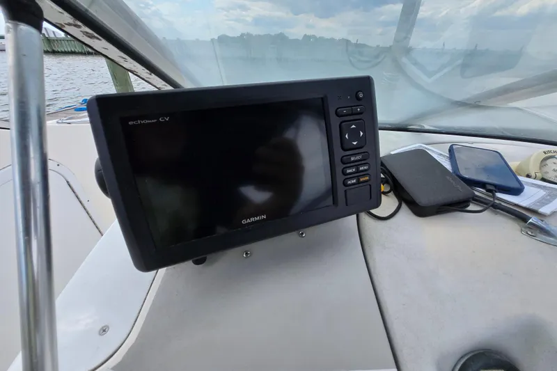 Slide: The Image of Garmin echomap CV on 1996 Wellcraft 2600s Eclipse Bowrider dashboard, with phone and accessories. - 16