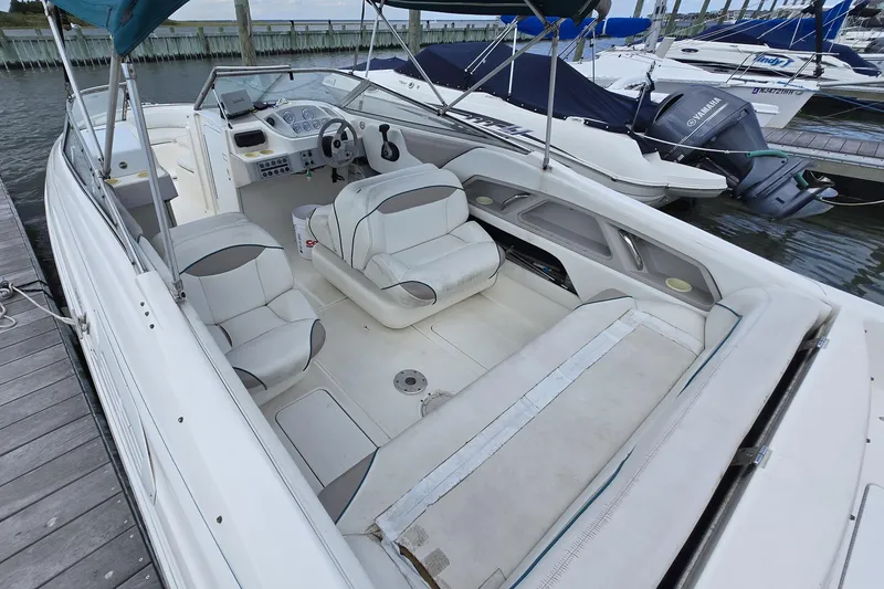 Slide: The Image of 1996 Wellcraft 2600s Eclipse Bowrider with white interior, docked at marina. - 2