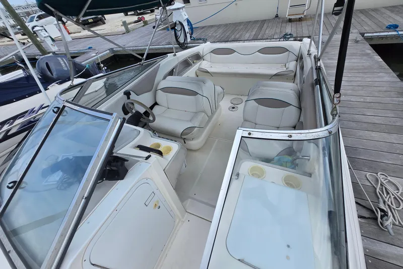 Slide: The Image of 1996 Wellcraft 2600s Eclipse Bowrider with spacious seating and modern dashboard at dock. - 5