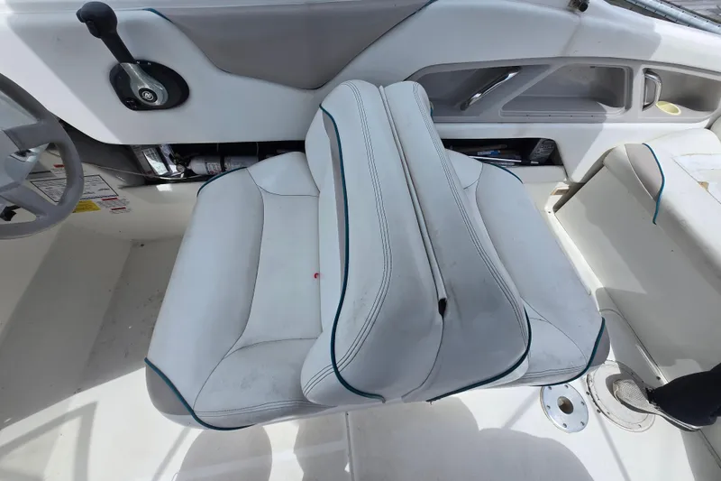 Slide: The Image of 1996 Wellcraft 2600s Eclipse Bowrider interior with white seating and control panel. - 8