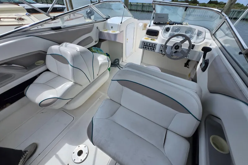 Slide: The Image of 1996 Wellcraft 2600s Eclipse Bowrider interior with white seating and steering console. - 9