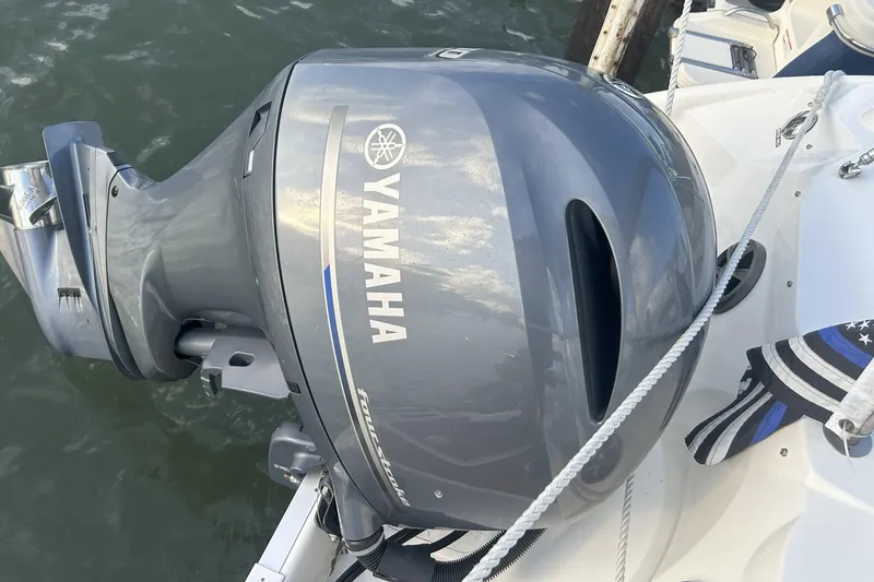Slide: The Image of Yamaha outboard motor on 2018 NauticStar 243DC Sport Deck boat, docked on water. - 20