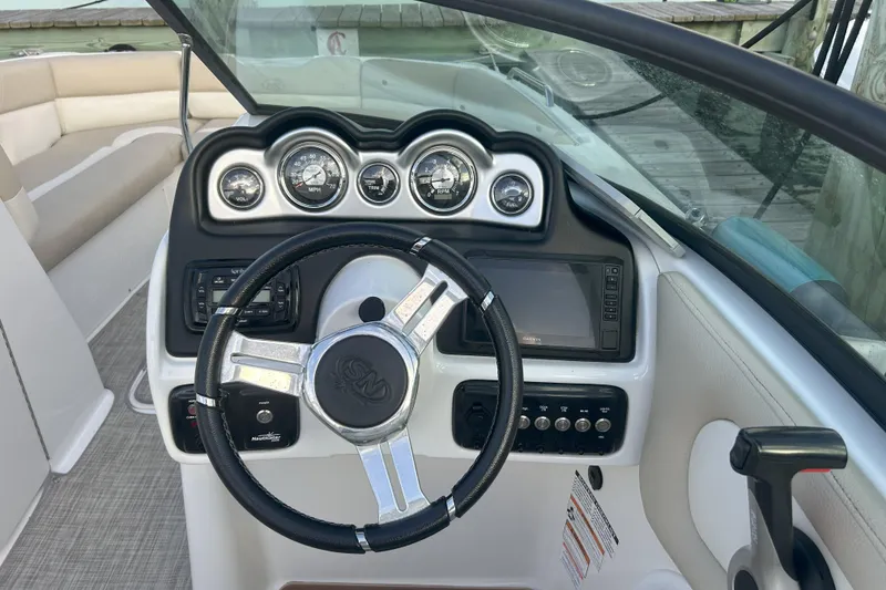 Slide: The Image of 2018 NauticStar 243DC Sport Deck boat dashboard with steering wheel and gauges. - 8
