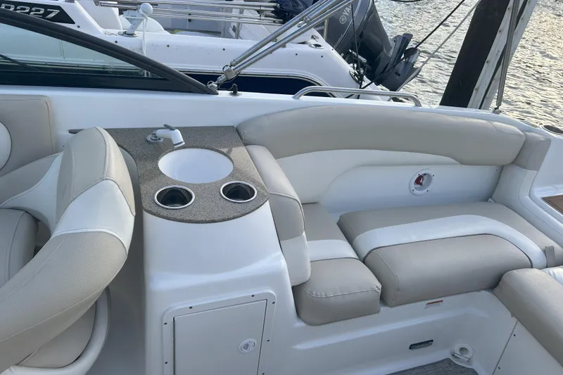 Slide: The Image of 2018 NauticStar 243DC Sport Deck interior with seating and built-in sink. - 9