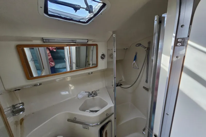 Slide: The Image of Bathroom interior of 1994 Sea Ray 400 Express Cruiser with shower and sink. - 11