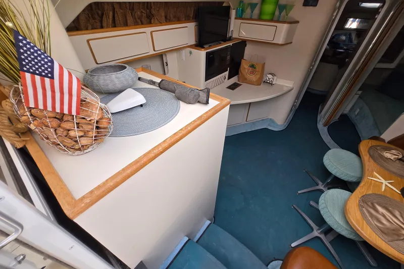 Slide: The Image of Interior of 1994 Sea Ray 400 Express Cruiser with American flag and modern decor. - 13