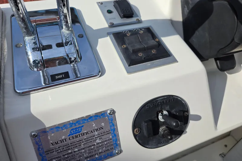 Slide: The Image of 1994 Sea Ray 400 Express Cruiser control panel with shift lever and yacht certification. - 20