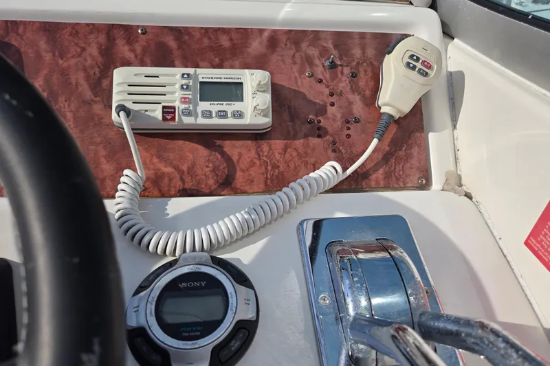 Slide: The Image of Control panel of a 1994 Sea Ray 400 Express Cruiser with radio and throttle. - 23