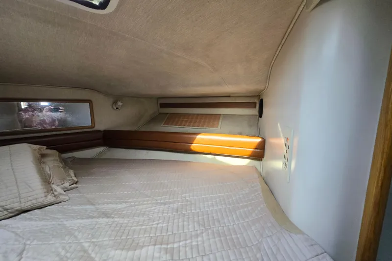 Slide: The Image of 1994 Sea Ray 400 Express Cruiser cabin interior with bed and window. - 24