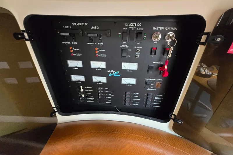 Slide: The Image of Control panel of a 1994 Sea Ray 400 Express Cruiser with various switches and gauges. - 29