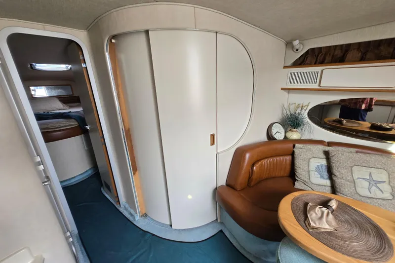 Slide: The Image of Interior of 1994 Sea Ray 400 Express Cruiser with cozy seating and cabin view. - 30