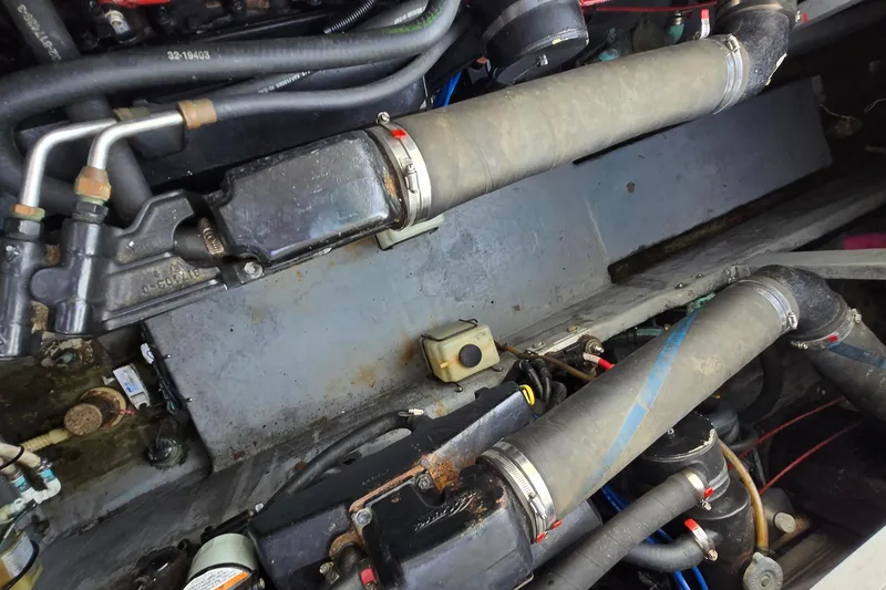 Slide: The Image of Engine compartment of a 1994 Sea Ray 400 Express Cruiser with visible hoses and components. - 31