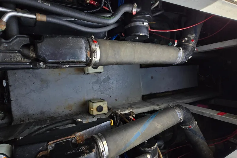 Slide: The Image of Engine compartment of a 1994 Sea Ray 400 Express Cruiser, showing hoses and components. - 32