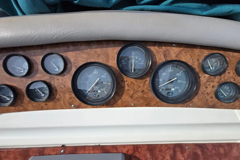 Slide: The Image of Dashboard of a 1994 Sea Ray 400 Express Cruiser with various gauges and instruments. - 33