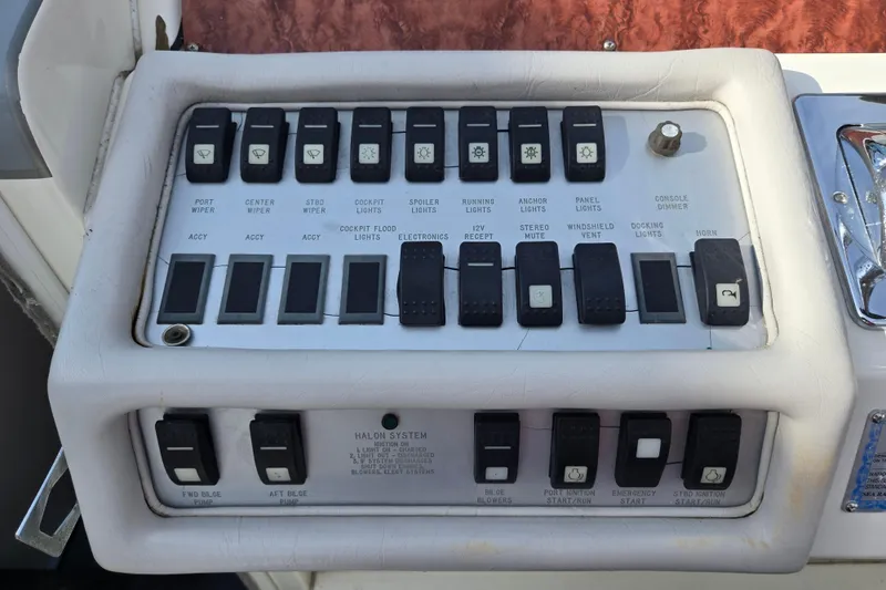 Slide: The Image of Control panel of a 1994 Sea Ray 400 Express Cruiser with various switches and labels. - 34