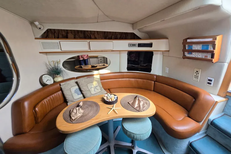 Slide: The Image of 1994 Sea Ray 400 Express Cruiser interior with curved seating and dining area. - 4