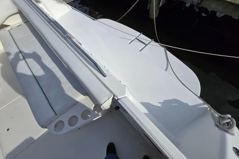 Slide: The Image of 1994 Sea Ray 400 Express Cruiser deck with seating and cup holders. - 41