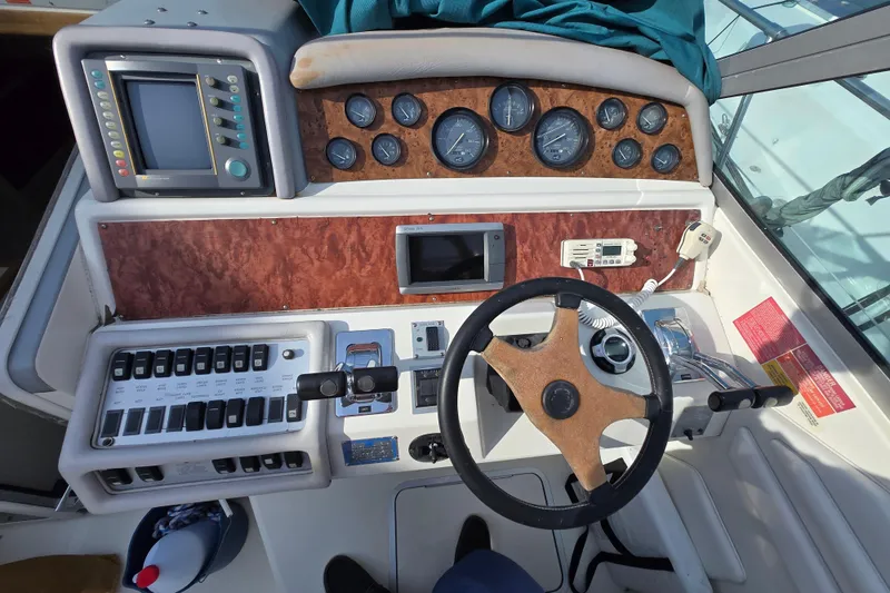 Slide: The Image of 1994 Sea Ray 400 Express Cruiser helm with gauges, controls, and navigation equipment. - 6